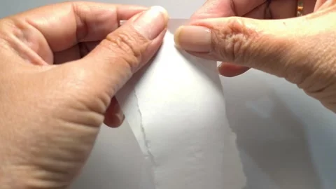 Close Up of Hands Ripping White Paper Apart Real Time 動画素材 339648697