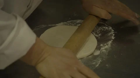 Close-Up of Hands Rolling Dough on Floured Surface in Beijing Street Food Stock Footage 345886600