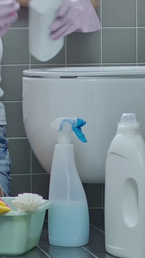Close-up of hands in rubber gloves cleaning toilet bowl with brush and dete.. Stock Footage 344764891