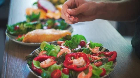 Close up of Hands Salt Salad Slow Motion. Fresh Green vegetables and Shrimps. Stock Footage 114667382