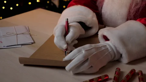 Close up hands Santa Claus writes congratulations children on New Year holidays Stock Footage 165268288