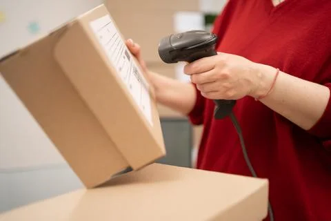 Close up of hands scanning barcode on parcel package for shipment, supporti.. Stock Photos