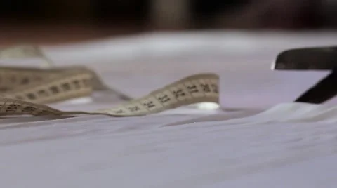 Close up of hands with scissors cutting white material Stock Footage 67613770