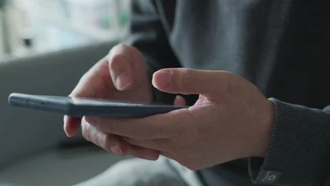 Close up of hands, scrolling and selecting on phone Stock Footage 260336746