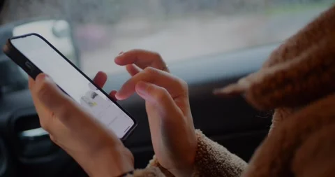 Close-up of hands scrolling right to left on a smartphone screen inside... Stock Footage 319882325