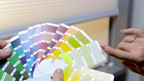 Close up of hands scrolling through a color guide Stock Footage 82076802