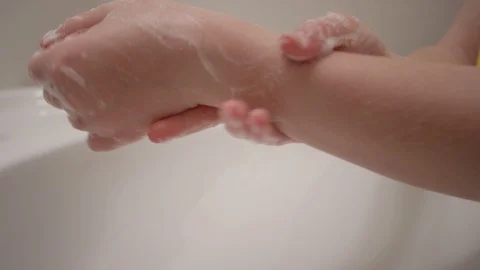 Close up of hands scrubbing thoroughly and making soap bubbles in slow motion Stock Footage 128919884