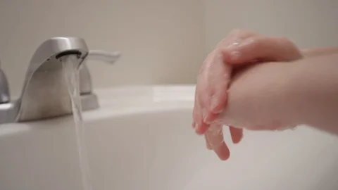 Close up of hands scrubbing thoroughly and making soap bubbles in slow motion Stock Footage 128920028