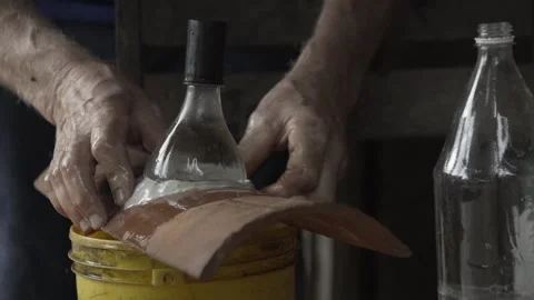 Close-up of Hands Sealing Solar Bottle Light on Roof Tile with Caulk, Conde Stock Footage 320571237