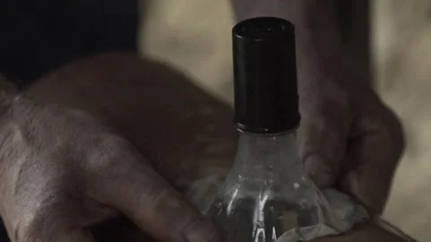 Close-up of Hands Sealing Solar Bottle Light on Roof Tile with Caulk, Conde Stock Footage 320571268