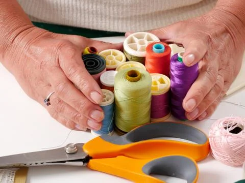 Close-up of the hands of a seamstress Stock Photos
