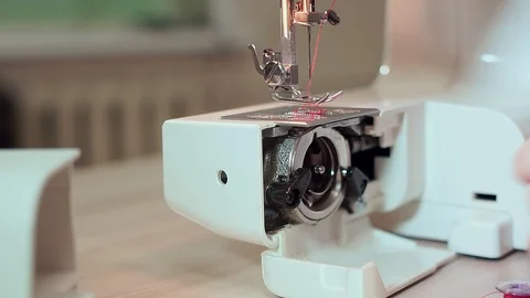 Close-up, hands of a seamstress take out threads for a bobbin. Slow motion Видео 101869558