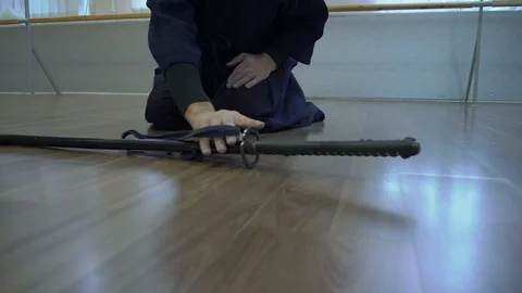 Close-up, Hands Seated on the Samurai Floor Pick up Lying on the Floor Katana's Stock Footage 85920277
