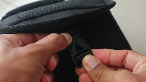 Close Up Hands Securing Backpack Clip Lock Indoors Stock Footage 334941595