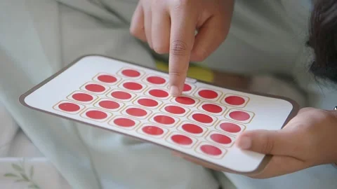 Close-Up Of Hands Selecting Red Reward Stickers From A Sticker Sheet For Stock Footage 346194496