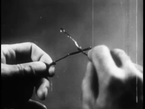 Close-up hands sending morse code with wires Stock Footage 260248859