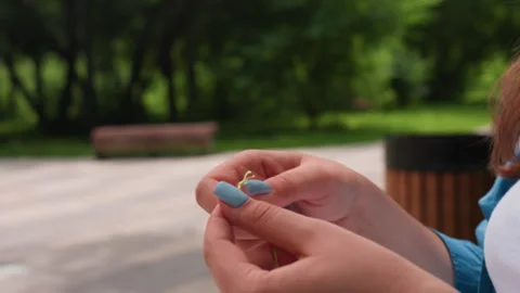 Close Up Hands Separating Green Thread in Park Stock Footage 330599716