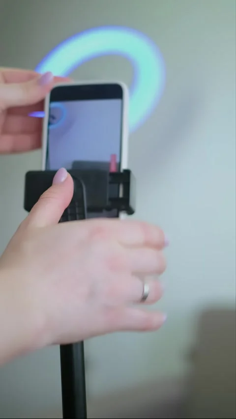 Close-up of hands setting up phone for vlog at home, photographer adjusting equi Stock Footage 276183212