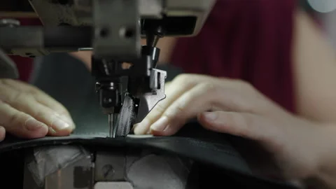 Close Up of Hands Sewing Leather on Industrial Machine in Shoe Manufacturing Stock Footage 341669309