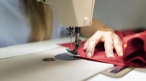 Close up hands sewing with machine. High quality photo Stock Photos