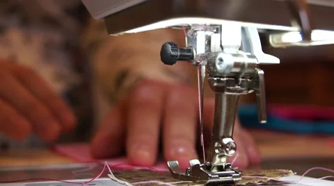 Close up hands at sewing machine needle going in and out pink thread Stock Footage 43666233