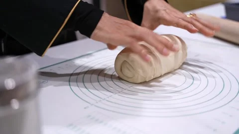 Close Up Hands Shaping Bread Dough on Pastry Mat During Indoor Home Baking Stock Footage 332068600