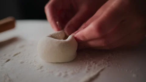 Close-up of hands shaping dough into a ball Stock Footage 336050993