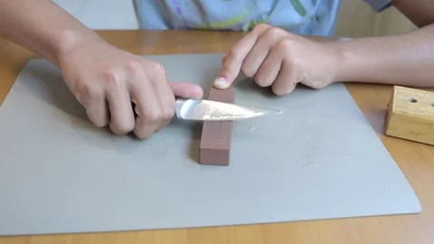 Close-up of hands sharpening knife on whetstone at home. Concept of kitchen Video stock 316088947