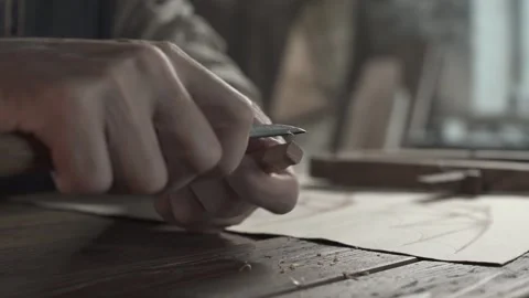 Close up of hands shaving a small wooden block with a knife tool 스톡 동영상 337930136