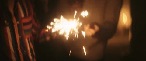 Close up of hands with the shiny sparkler Stock Footage 202258337