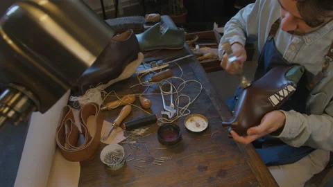 Close up hands shoemaker sews shoes to order. Shoe manufacturing workshop Stock Footage 137403406