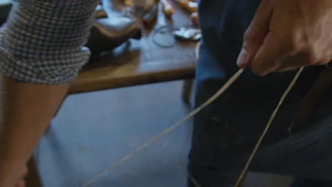 Close up hands shoemaker sews shoes to order. Shoe manufacturing workshop Video stock 137574560