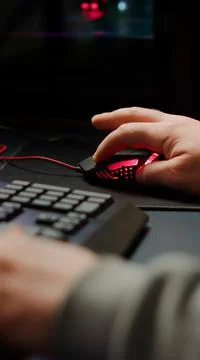 Close up hands shot of man player typing on RGB keyboard Stock Photos