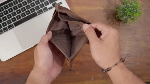Close-up of hands showing an empty wallet, symbolizing financial problems Stock Footage 334770762
