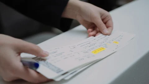 Close up Hands showing on tickets the time and gate departure, Airport Stock Footage 109285244