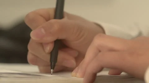 Close-up of Hands Signing Documents with Black Pen on Desk Vidéo 334861267