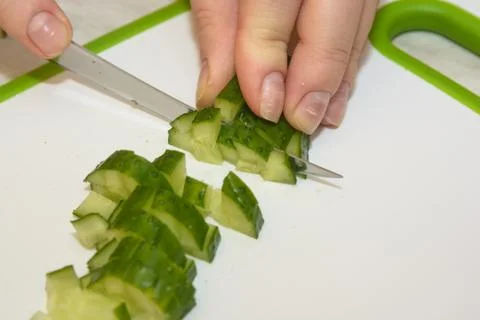 Close-up of hands slicing cucumber Stock Photos