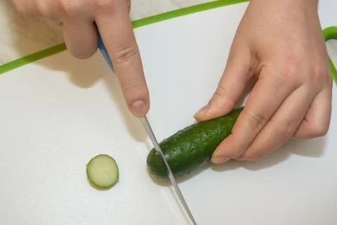 Close-up of hands slicing cucumber Stock Photos