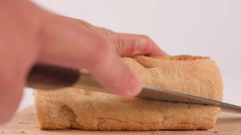 Close Up of Hands Slicing Fresh Crusty Bread on Wooden Board Stock Footage 337224894