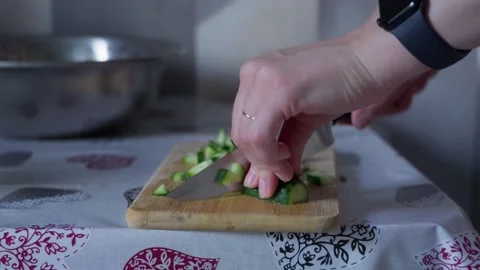 Close Up of Hands Slicing Fresh Cucumber on Wooden Cutting Board Stock Footage 341767000