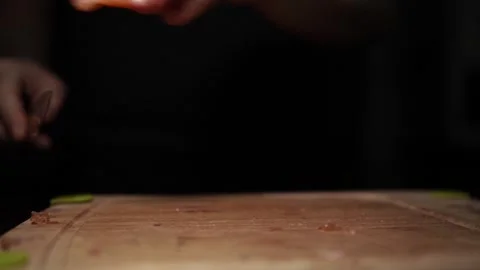 Close-Up of Hands Slicing Fresh Salmon Fillet on a Dark Background Stock-Footage 296232646