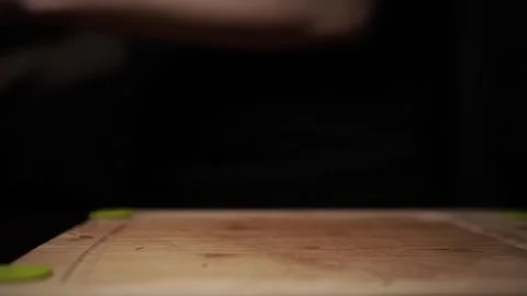 Close-Up of Hands Slicing Fresh Salmon Fillet on a Dark Background Stock Footage 296422097