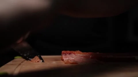 Close-Up of Hands Slicing Fresh Salmon Fillet on a Dark Background 스톡 동영상 296426114