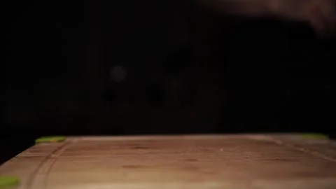 Close-Up of Hands Slicing Fresh Salmon Fillet on a Dark Background Stock Footage 296426719