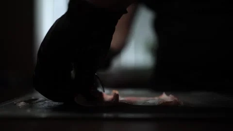 Close-Up of Hands Slicing Fresh Salmon Fillet on a Dark Background Stock-Footage 296428579