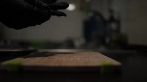 Close-Up of Hands Slicing Fresh Salmon Fillet on a Dark Background 스톡 동영상 303891248