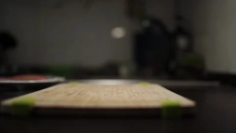 Close-Up of Hands Slicing Fresh Salmon Fillet on a Dark Background Stock Footage 303891283
