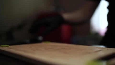 Close-Up of Hands Slicing Fresh Salmon Fillet on a Dark Background Stock Footage 303891841