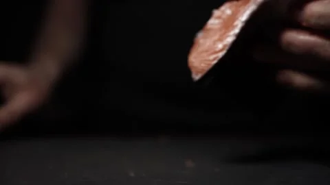 Close-Up of Hands Slicing Fresh Salmon Fillet on a Dark Background Stock Footage 303892248