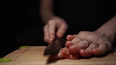 Close-Up of Hands Slicing Fresh Salmon Fillet on a Dark Background 스톡 동영상 303895412